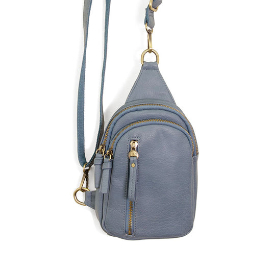 A blue faux leather sling bag with a gold-tone strap and hardware, featuring a top zip closure and an exterior front zip pocket.